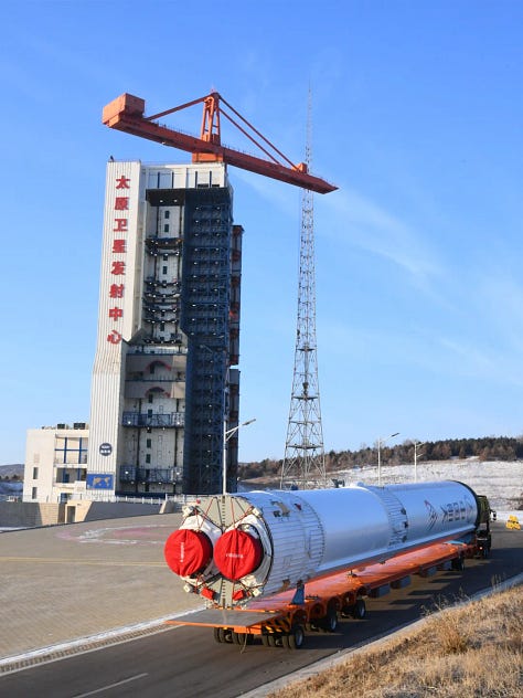 The Long March 6A's first-stage, second-stage, and fairing being transported and placed onto the launch pad.