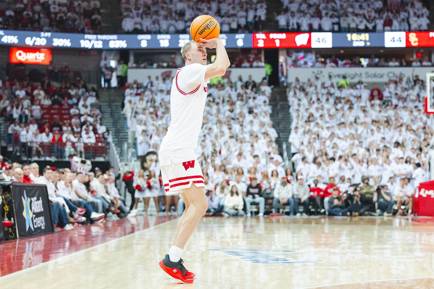 Rohde, wearing all white uniforms during a white-out game, attempts a shot with his right hand. Rohde, wearing all white uniforms during a white-out game, attempts a shot with his right hand.