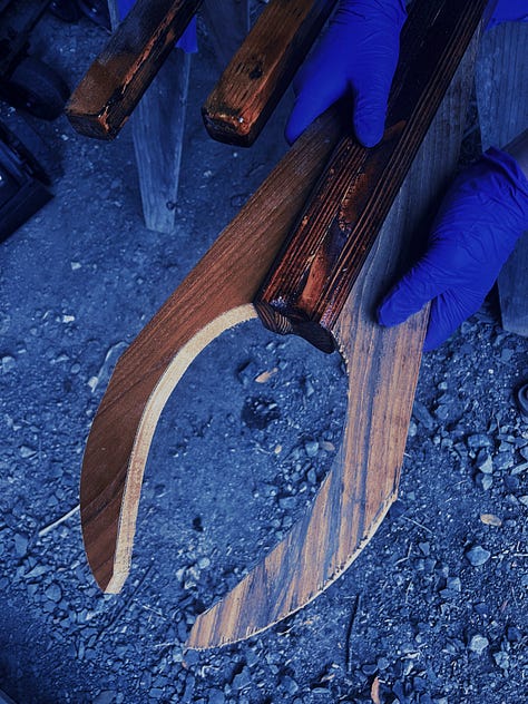 left is a sailing pueo handmade of wood, middle is a photo of wood projects for the canoe being clamped, and right is a photo from chriss POV of him climbing the mast to fix something he miscalculated on purpose to climb the mast