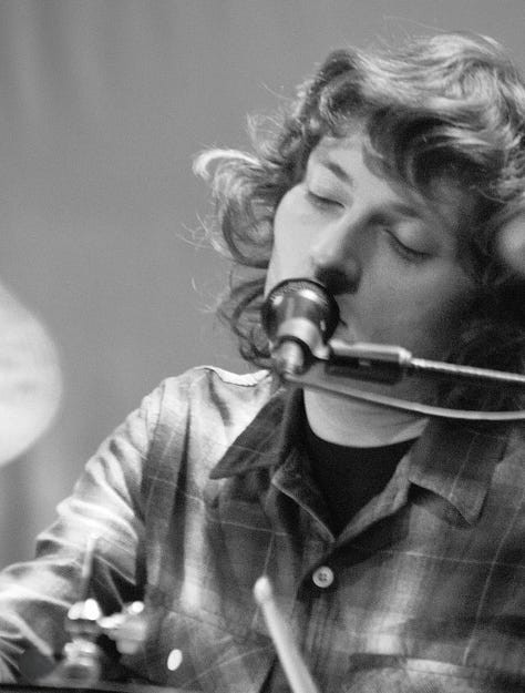 Black-and-white photos of each member of the Tweedy band performing live