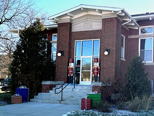 Red brick Carnegie library building with Art Deco font and capital C carved above entrance Red brick Carnegie library building with Art Deco font and capital C carved above entrance