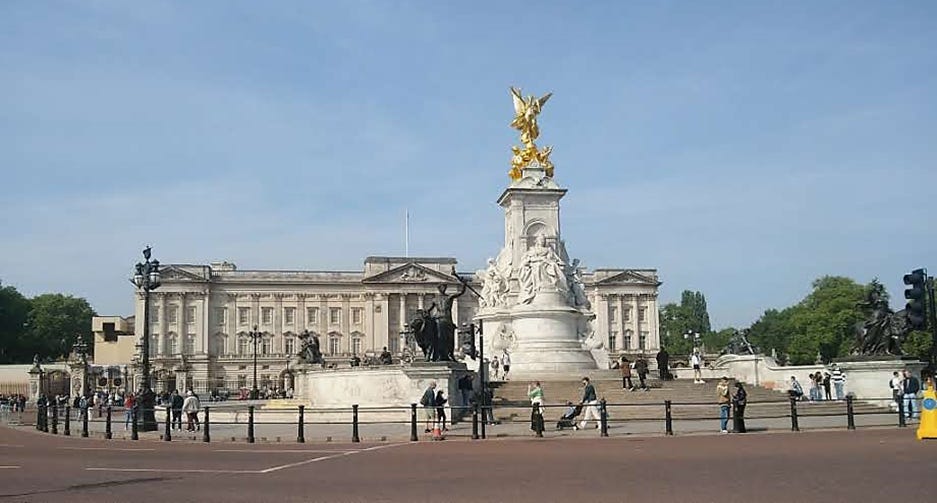 A large white building with a statue in front of it with Victoria Memorial, London in the background
AI-generated content may be incorrect. A large white building with a statue in front of it with Victoria Memorial, London in the background
AI-generated content may be incorrect.