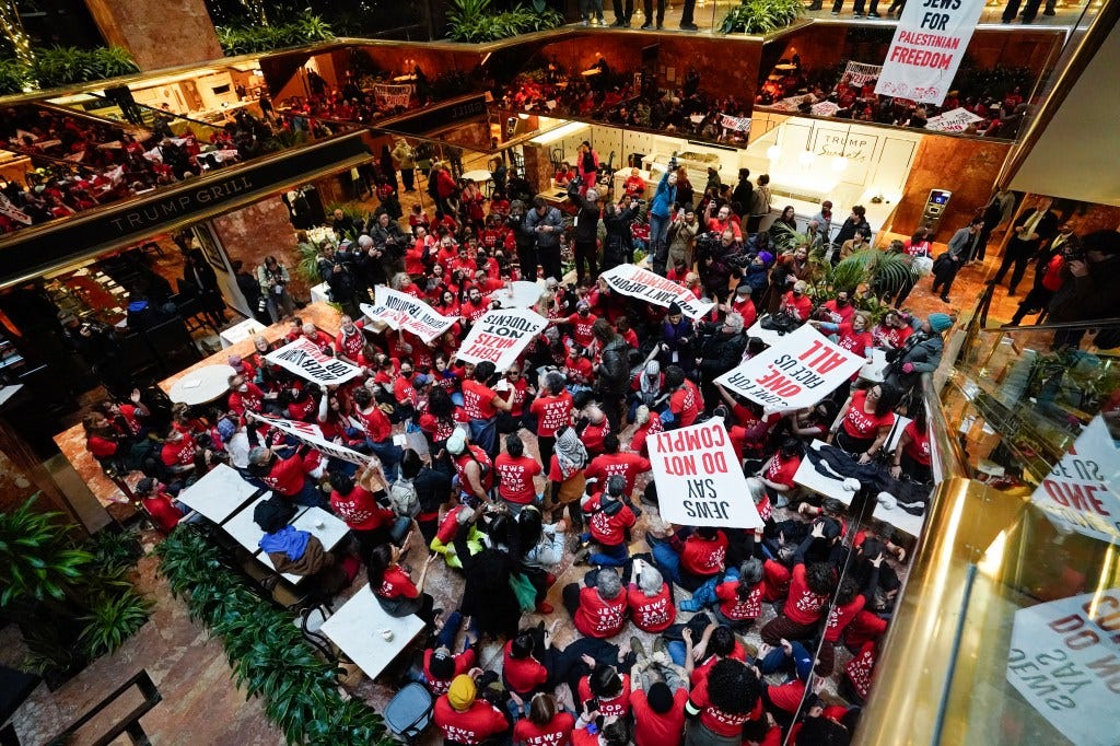 The protestors flooded the atrium of Trump Tower in Midtown East on Thursday. Ninety-eight were arrested