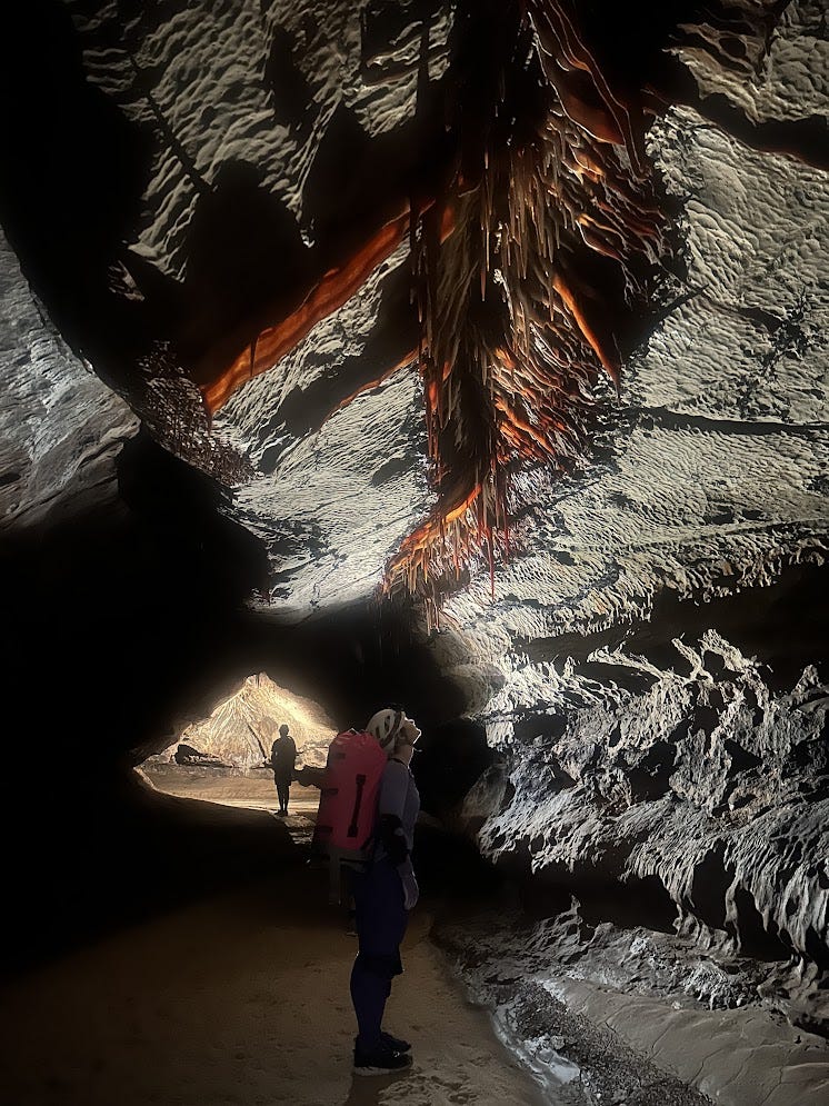 Riley standing on Snowy underneath some beautiful stalactites and cave bacon Riley standing on Snowy underneath some beautiful stalactites and cave bacon