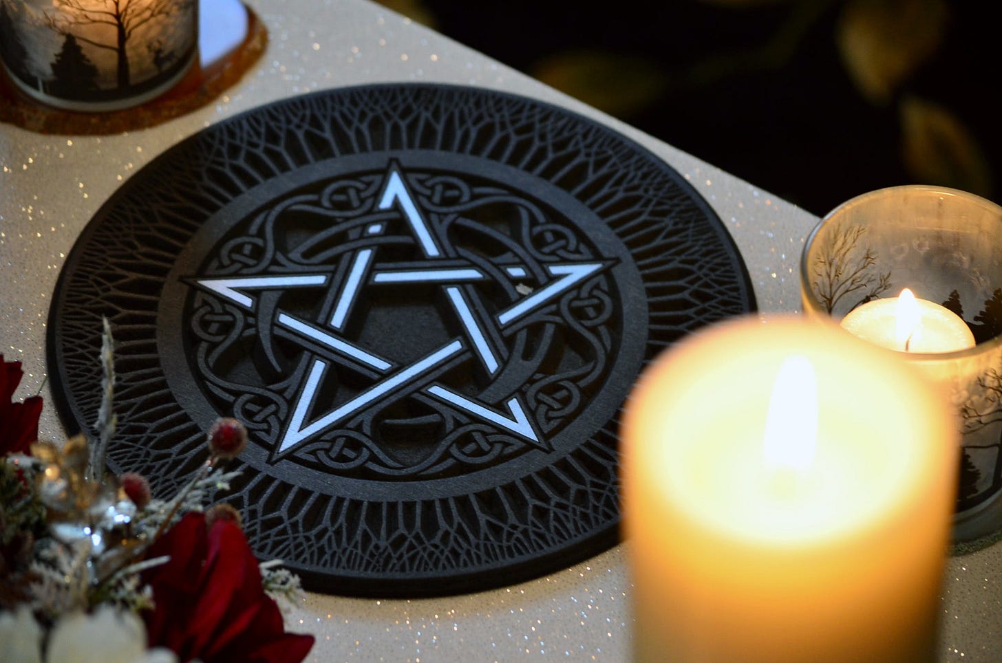 alter with five pointed star , candles, and dried flowers