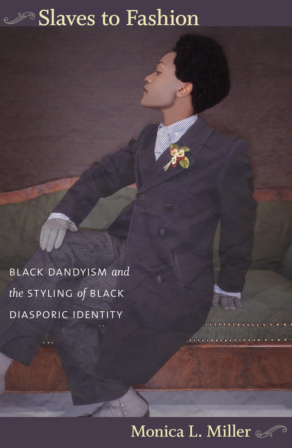 Cover of the book Slaves to Fashion by Monica L. Miller. It features a Black person styled in early 20th-century dandy fashion, wearing a double-breasted overcoat, striped trousers, gloves, and a decorative boutonniere. They are seated on a vintage green velvet couch with wooden trim, striking a poised, side-facing pose. The subtitle reads: Black Dandyism and the Styling of Black Diasporic Identity. The background is muted, focusing attention on the elegance of the figure’s attire and posture.