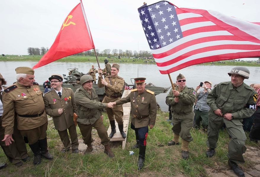 Amateur actors re-enact the link-up of Soviet and American troops during the 70th anniversary of ...