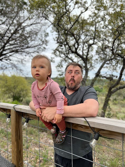 Han is sitting on a fence and Mike is holding him. They are having many sweet, affectionate, silly moments.