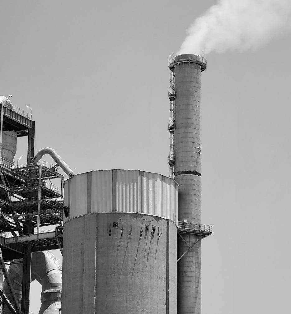 a factory with smoke stacks