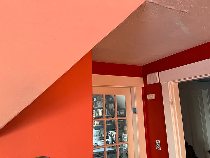 Image of two corners of a room where walls of different colors converge.