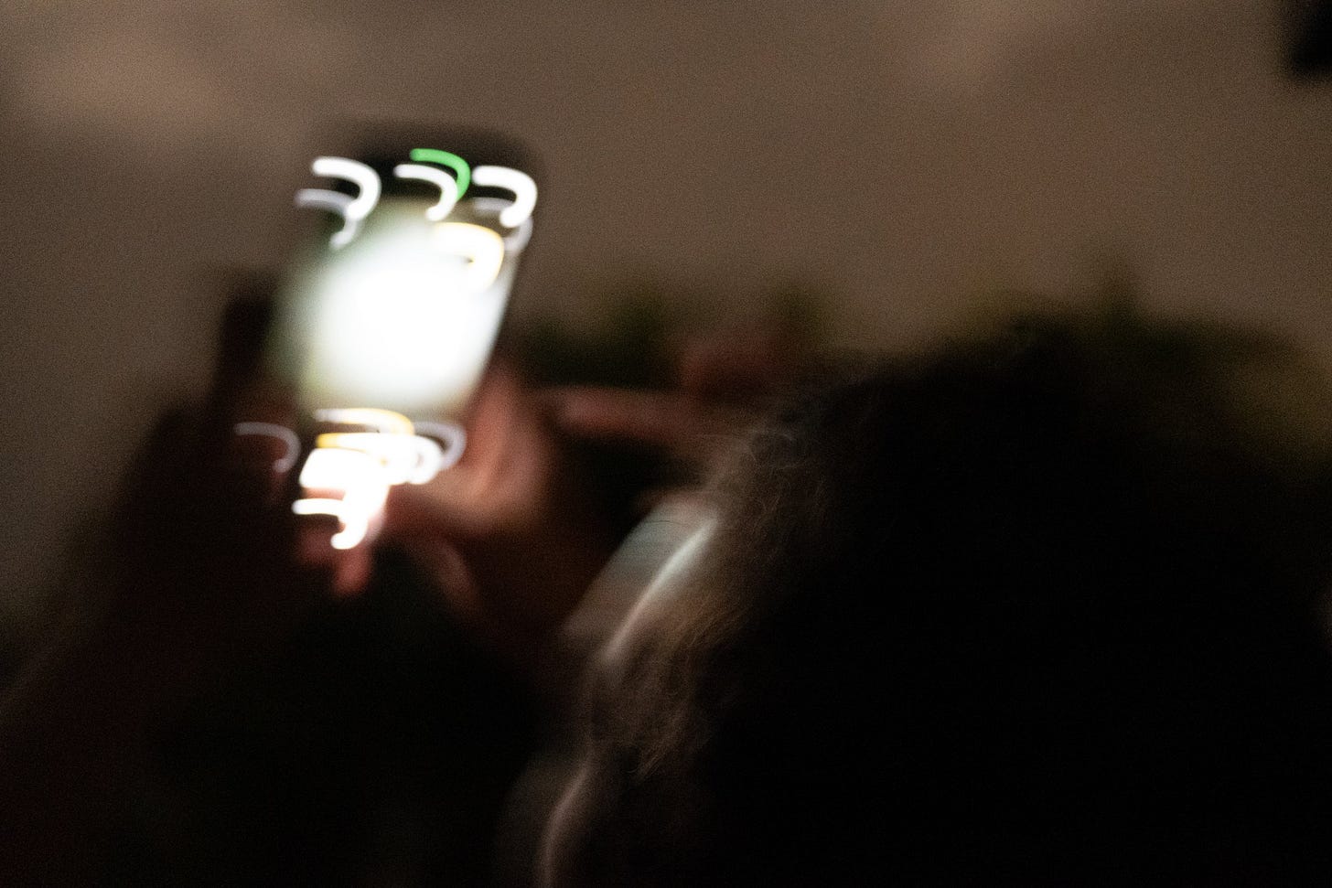 Person Taking a Photo at Night