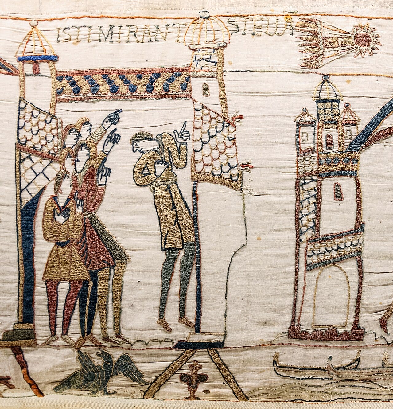 Bayeux Tapestry: men point at a comet with streamers in the top border, above the Latin words ISTI MIRANT STELLA