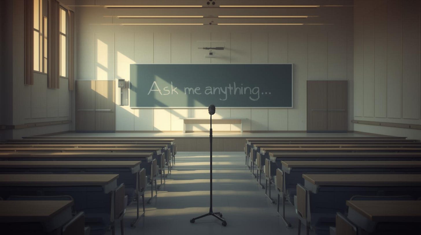  Empty lecture hall with a Q&A microphone in the aisle; “Ask me anything” written small on a chalkboard.