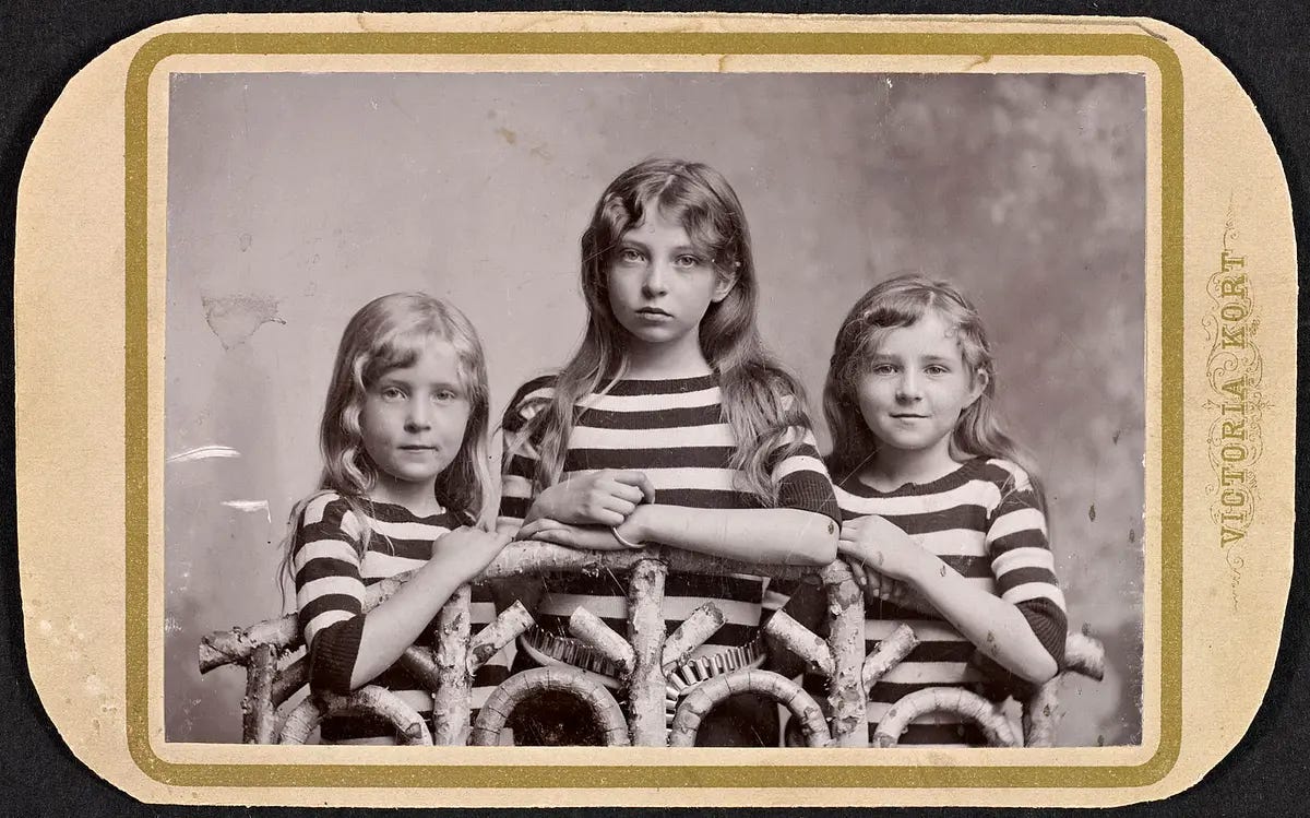 Sigrid Undset (C) with her younger sisters Signe and Ragnhild, in a 1894 photograph. (Public Domain)