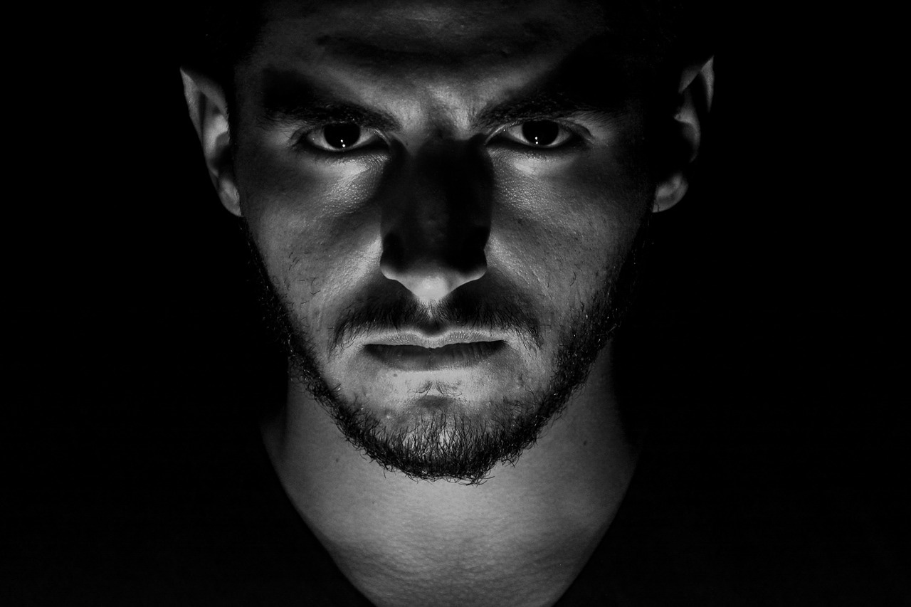 A black and white portrait of a young white man looking intently at the camera. He has a beard but not a very big one A black and white portrait of a young white man looking intently at the camera. He has a beard but not a very big one