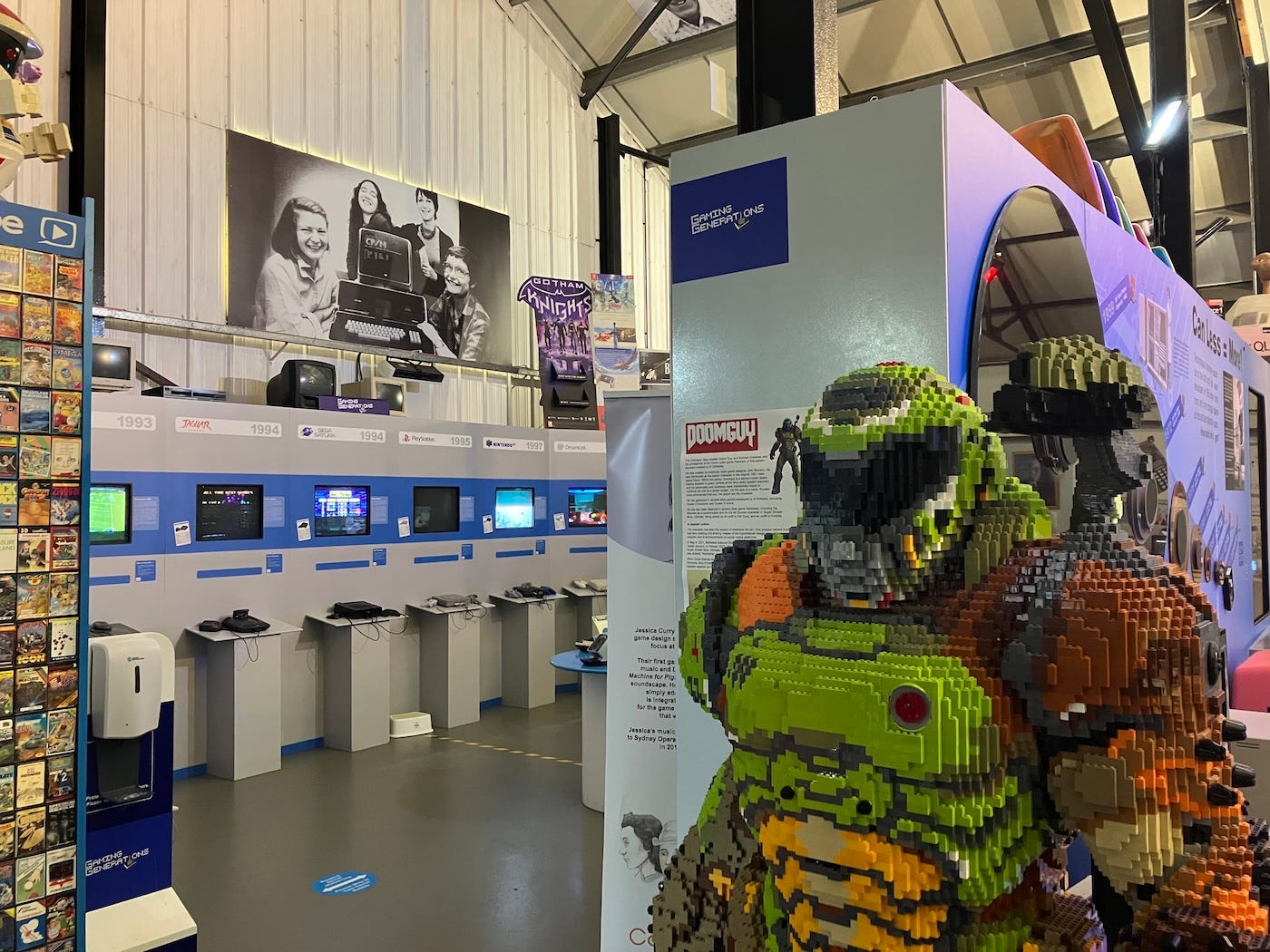 A life-size Lego Master Chief from Halo in front of old computer displays