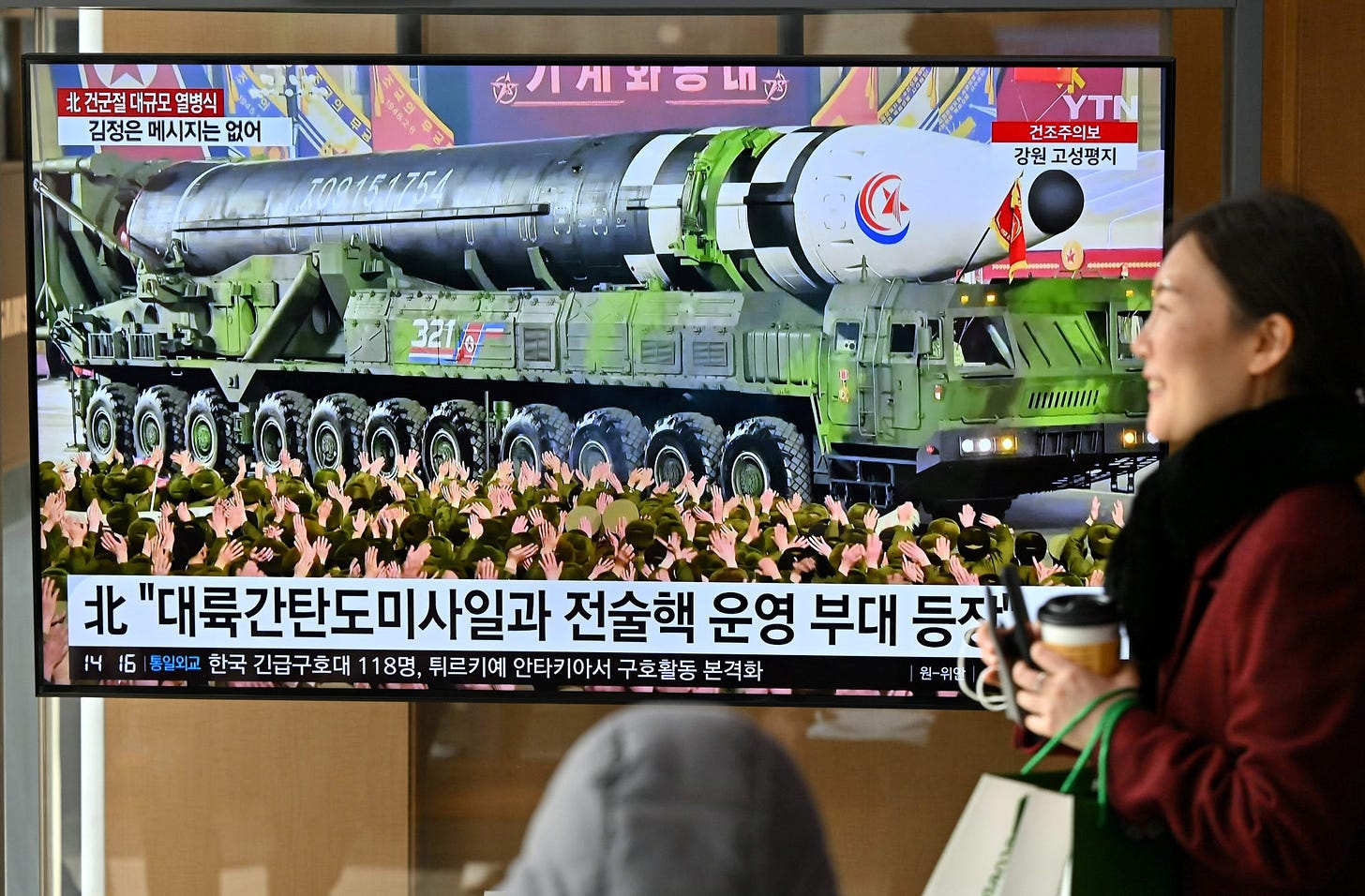 A woman walks past a television screen showing a news broadcast with an image of a North Korean military parade held in Pyongyang to mark the 75th founding anniversary of its armed forces, at a railway station in Seoul on February 9, 2023. - North Korea&#39;s Kim Jong Un oversaw a major military parade showcasing a record number of nuclear and intercontinental ballistic missiles, state media reported on February 9, including what analysts said was possibly a new solid-fueled ICBM. (Photo by Jung Yeon-je &#x2F; AFP) (Photo by JUNG YEON-JE&#x2F;AFP via Getty Images) Photographer: JUNG YEON-JE&#x2F;AFP