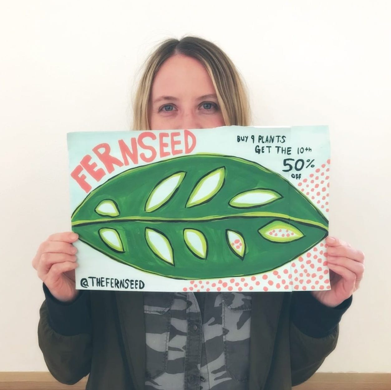 woman holding an oversized handmade customer loyalty card