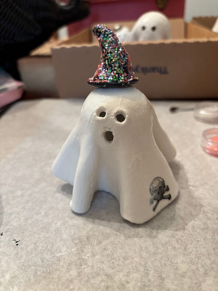 gallery of four clay ghosts decorated for Halloween