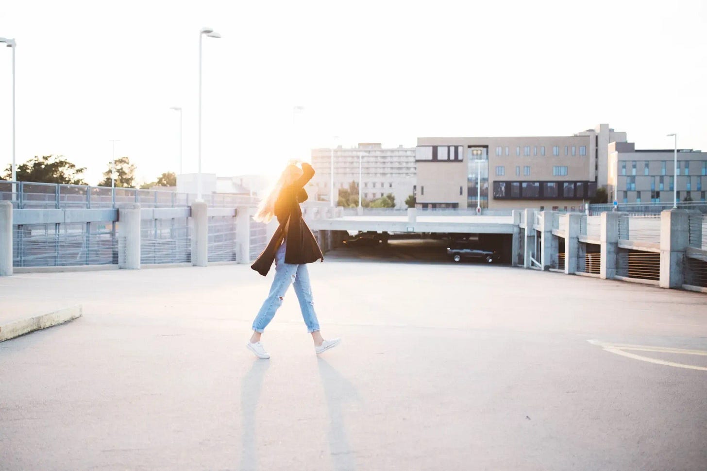 A woman walking in urban area in sunrise A woman walking in urban area in sunrise