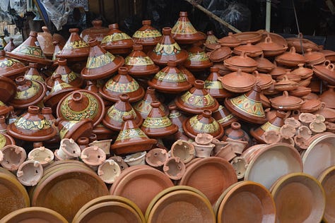 Scenes from Morocco featuring traditional architecture, vibrant souks, and cultural details - from geometric mosaic floors and colorful markets to local artisans and the famous goats in argan trees.