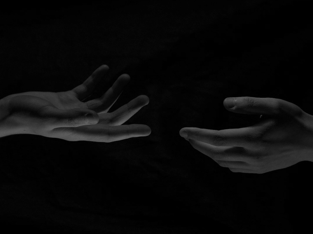 persons hand on black textile