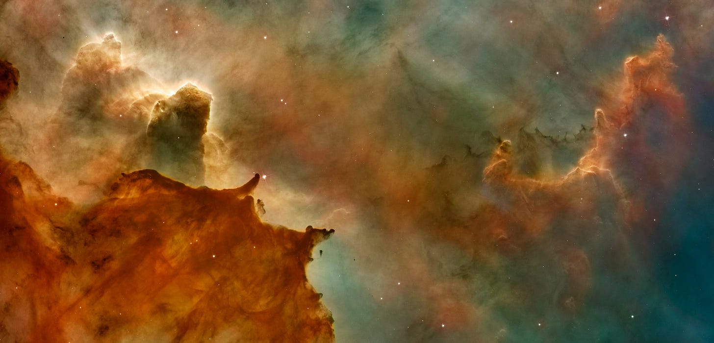 Colourised image of a nebula, mainly with red, orange and yellow hues