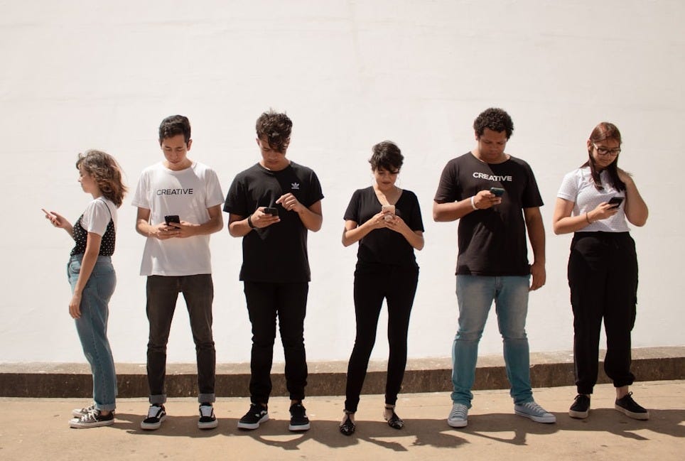 group of people standing on brown floor group of people standing on brown floor