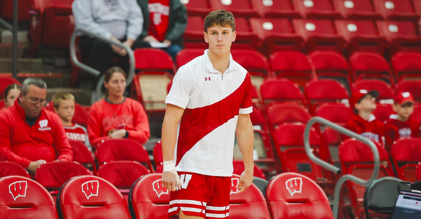 Zach Kinziger warming up on the Kohl Center court before the game, wearing a Wisconsin Badgers uniform