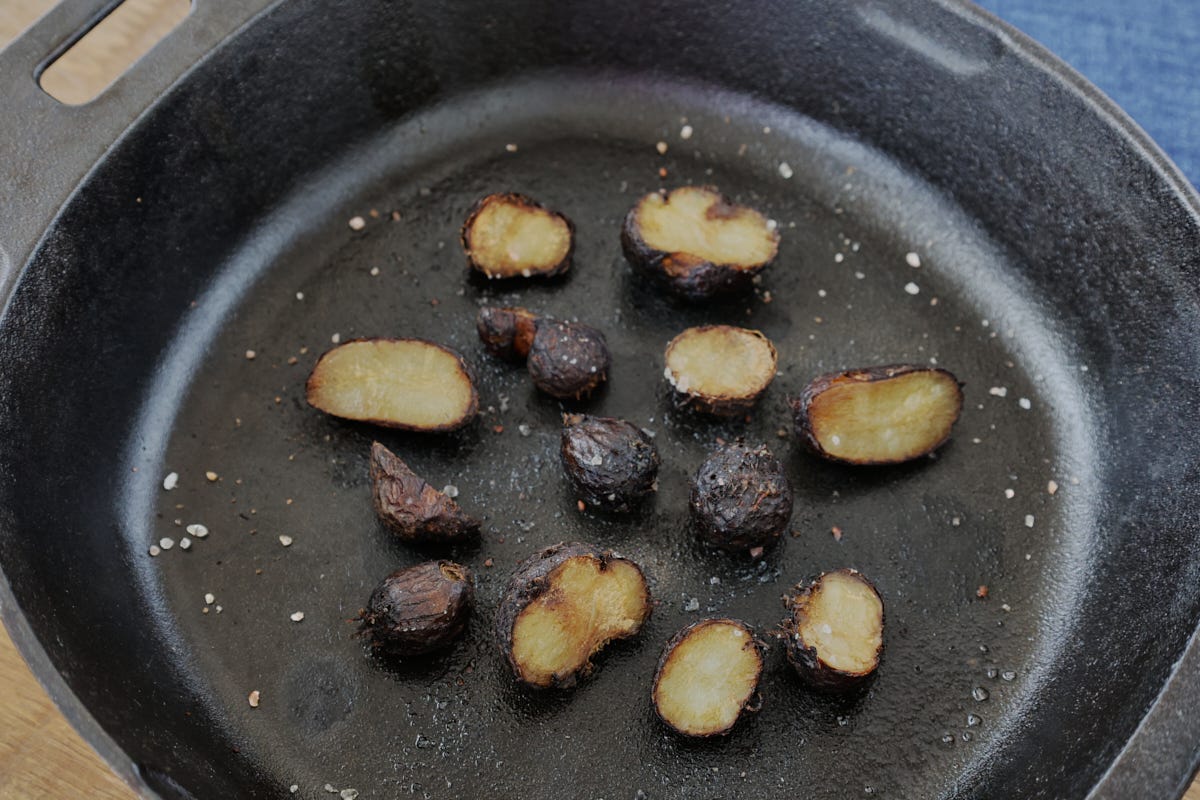 roasted african potato tubers in a cast iron skillet with a napkin roasted african potato tubers in a cast iron skillet with a napkin