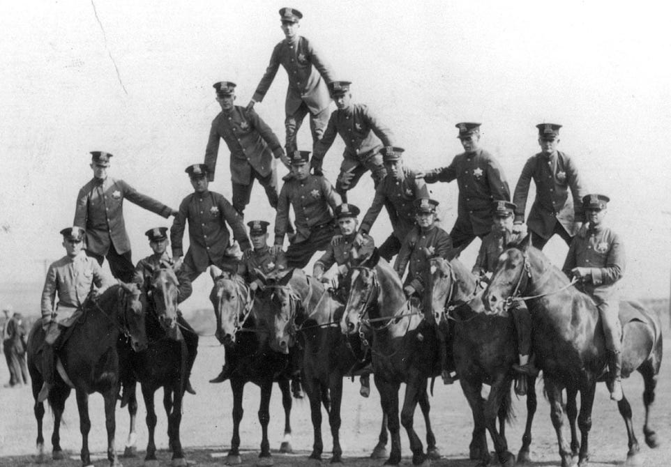 Chicago police officers and their horses forming a "human" pyramid.
