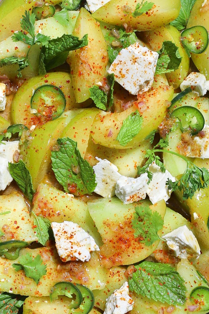 Close-up of melon, plum, and feta salad with chaat masala dressing