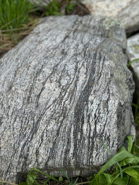 Images of rocks with repeated, waving patterns