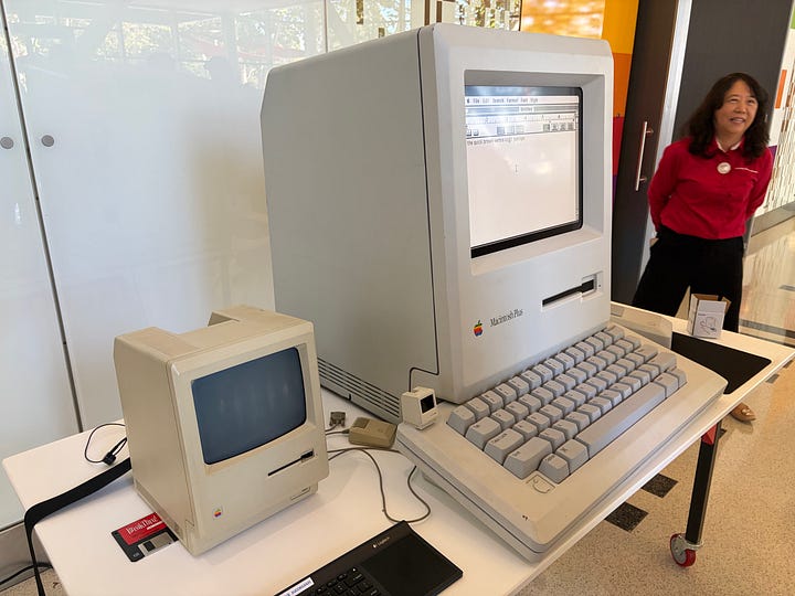 Two photos showing Big Mac, a 4:1 scale regular size replica of a Macintosh Plus, pico-mac-nano, a 62mm-high (1:5.5 scale) working replica of the original Mac, and an actual original Mac for scale. The author is holding the pico-mac-nano in the right-hand photo. Both photos were taken at Apple TechFest at the Computer History Museum.