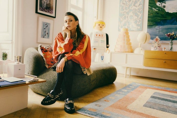 In her sitting room, with a FAT International Playmobil sculpture by Martin Grandits