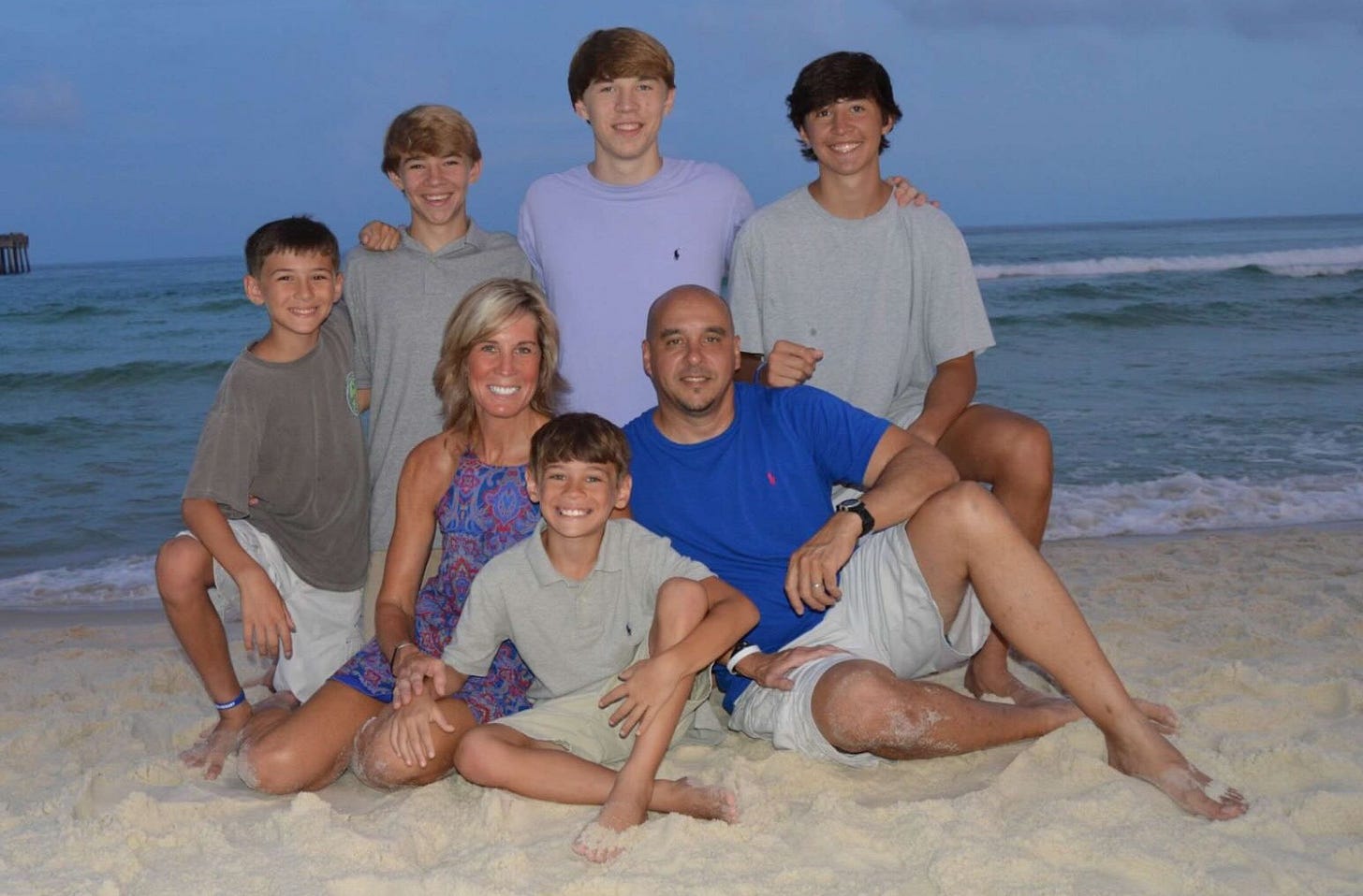 Family photo of Robin and Mark Lanzi with their five sons on the beach. Family photo of Robin and Mark Lanzi with their five sons on the beach.