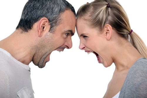 Woman and man facing each other, foreheads touching, shouting at each other.