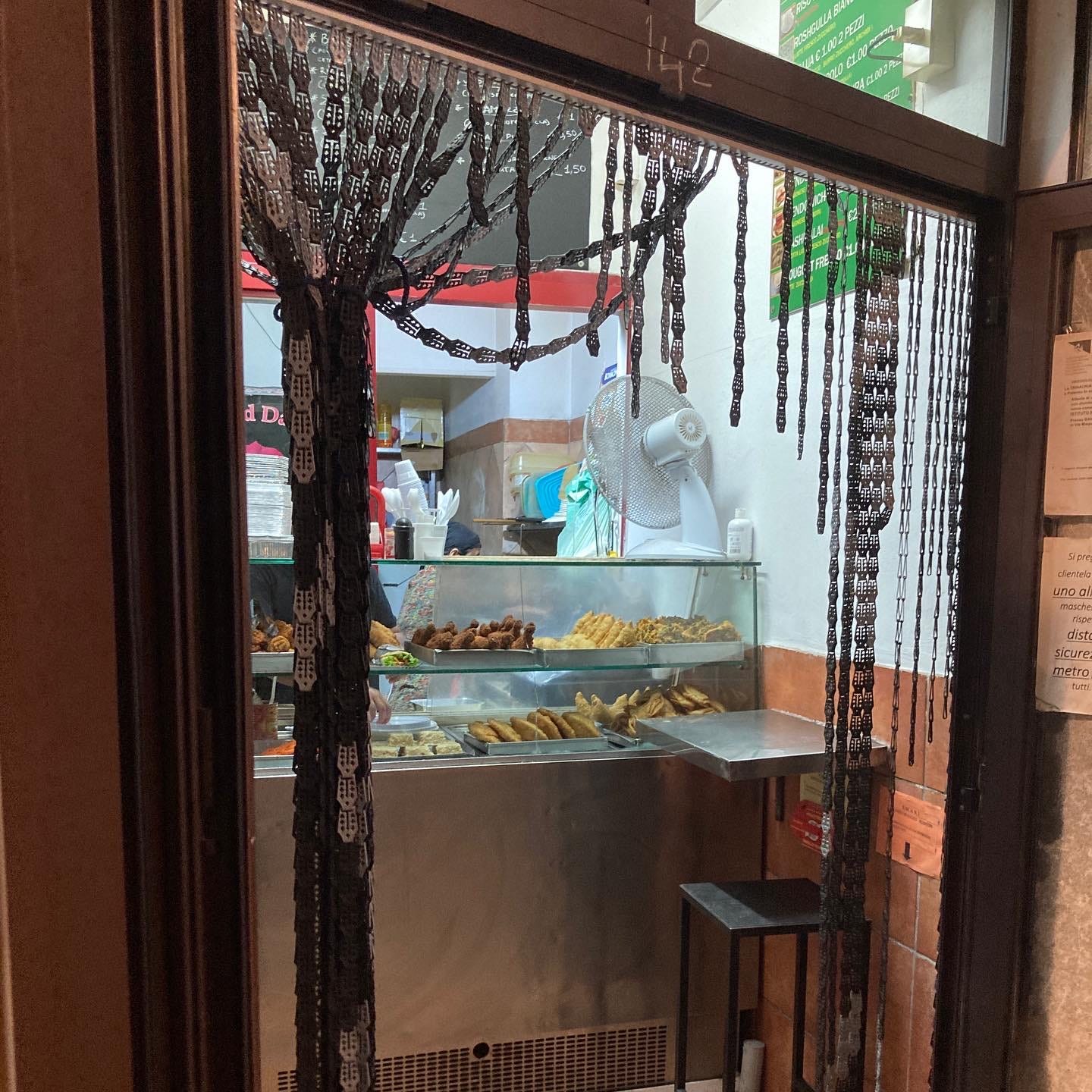 A small, hole-in-the-wall restaurant with snacks on display