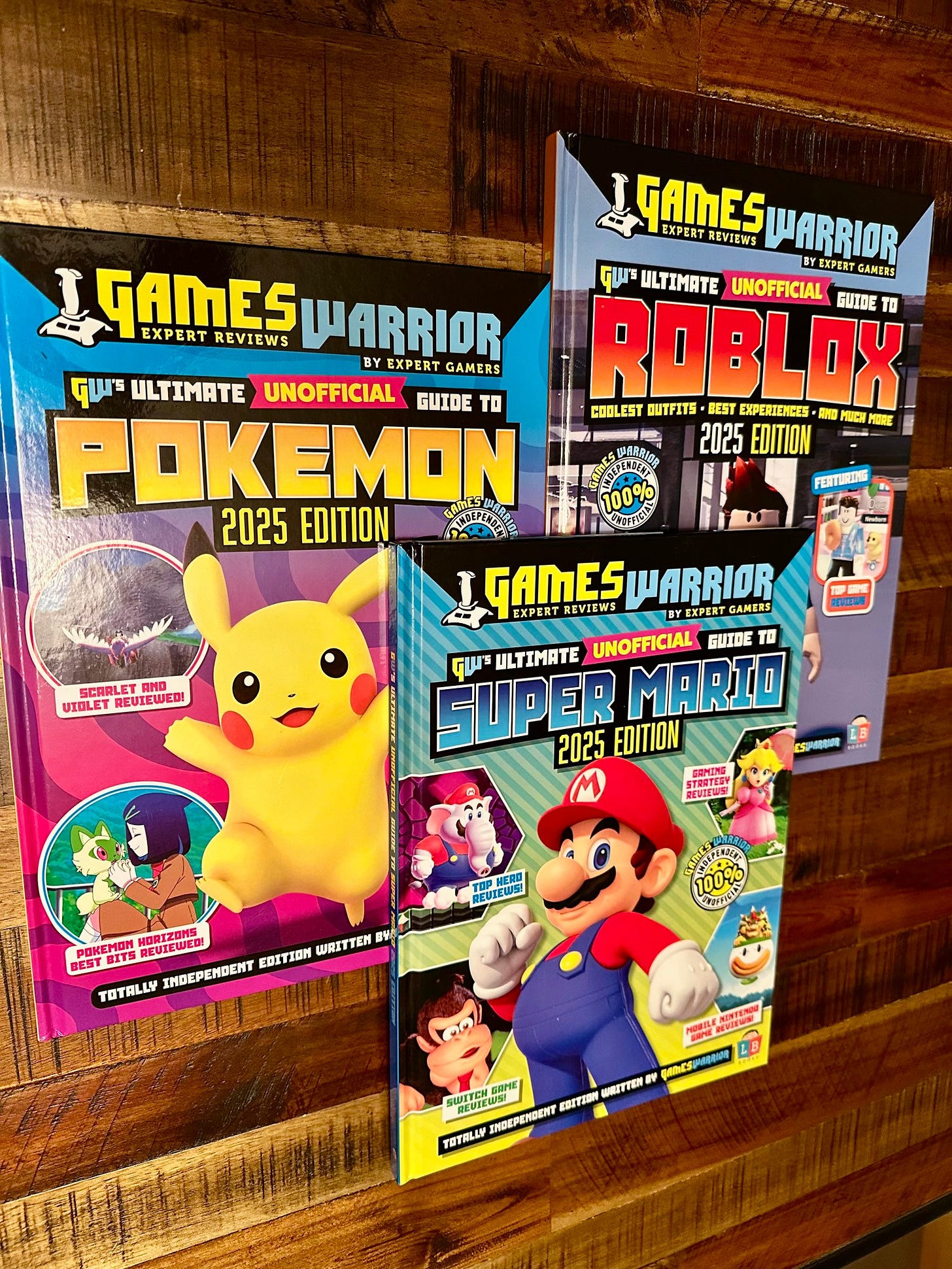 A trio of hardcover books based on Mario, Pokémon and Roblox