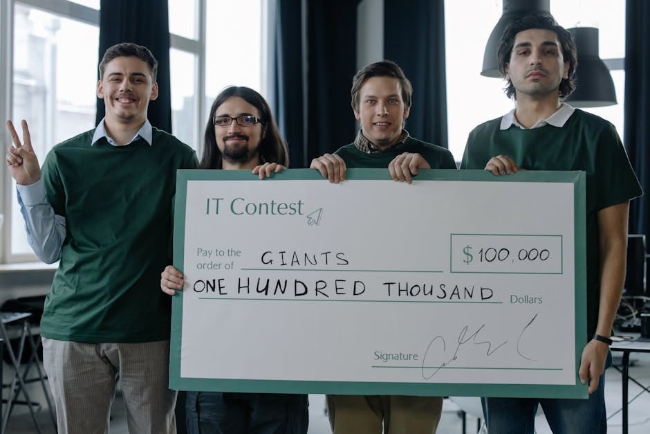 Winning Team of IT Developers Posing with a Huge Cheque Placard