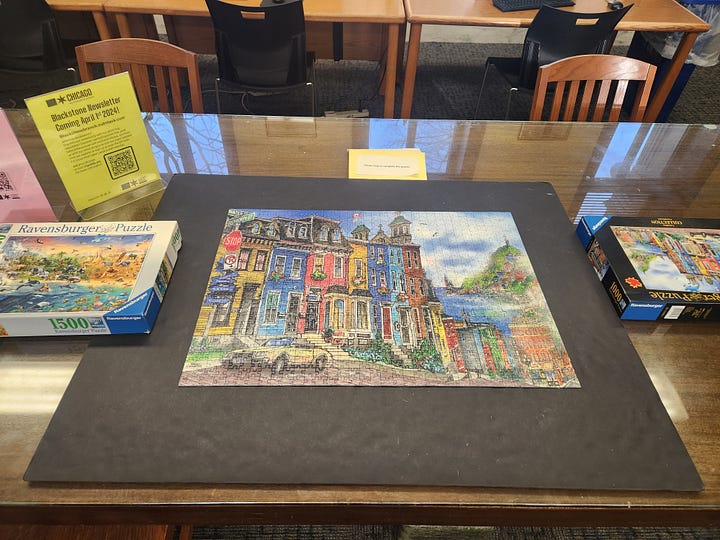 Image 1: Our puzzle gurus finished the job! Image 2: Our Chess Club in full swing Image 3: Our building on a beautiful winter day Image 4: A staff member's cat going on strike for more treats! Image 5: A staff member's cat who also wants to go on the trip