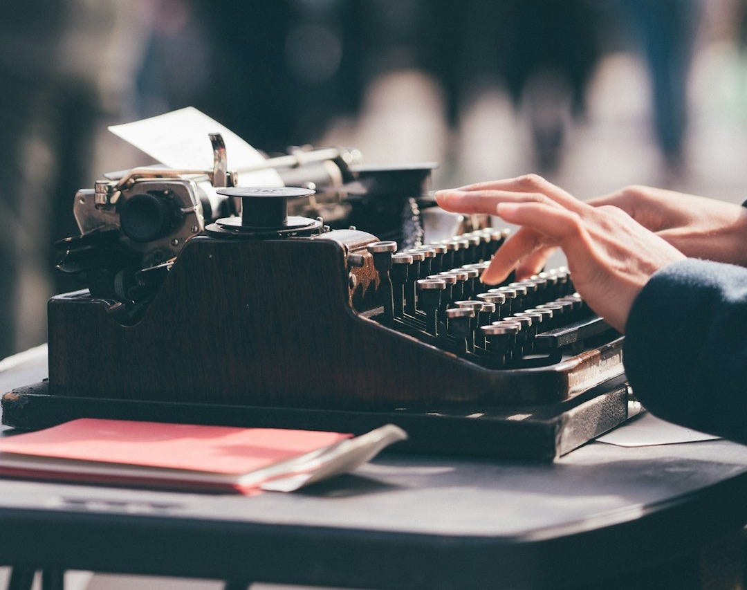 person using black typewriter
