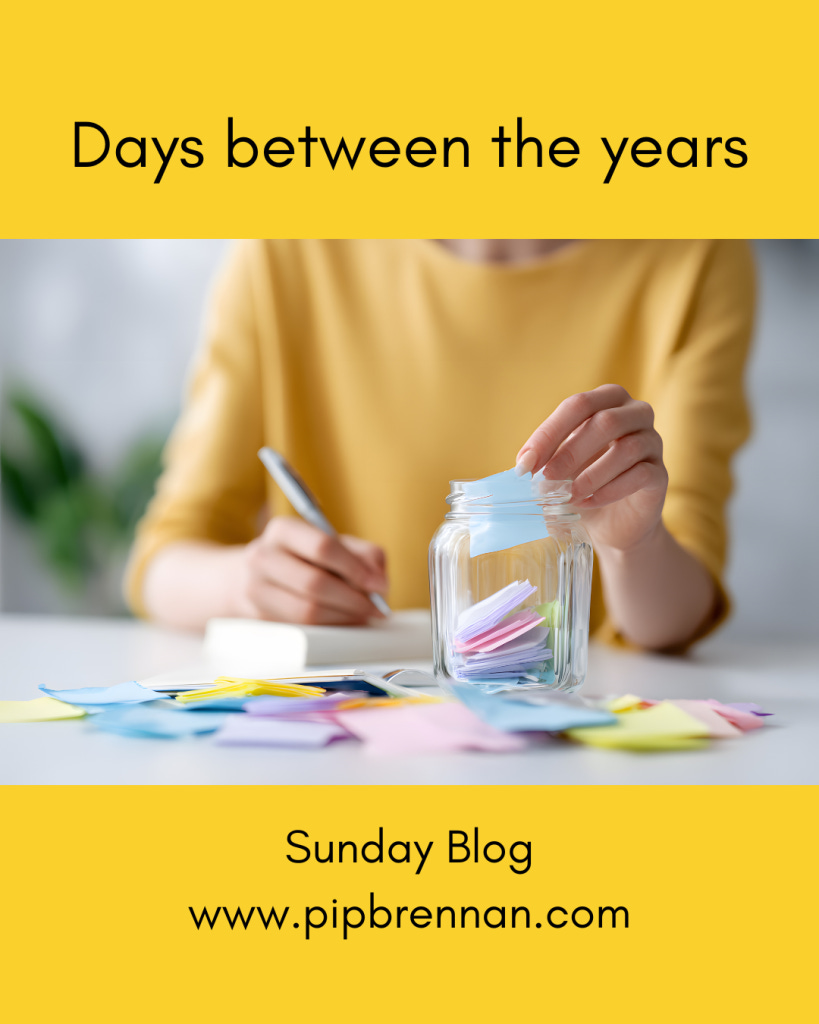 Days between the years - image of a jar where a woman is writing memories on bits of paper and putting them in the jar Days between the years - image of a jar where a woman is writing memories on bits of paper and putting them in the jar
