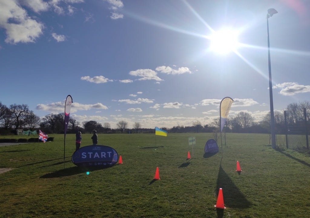 Flags and cones mark the finish, with the playing field stretching away under the sun