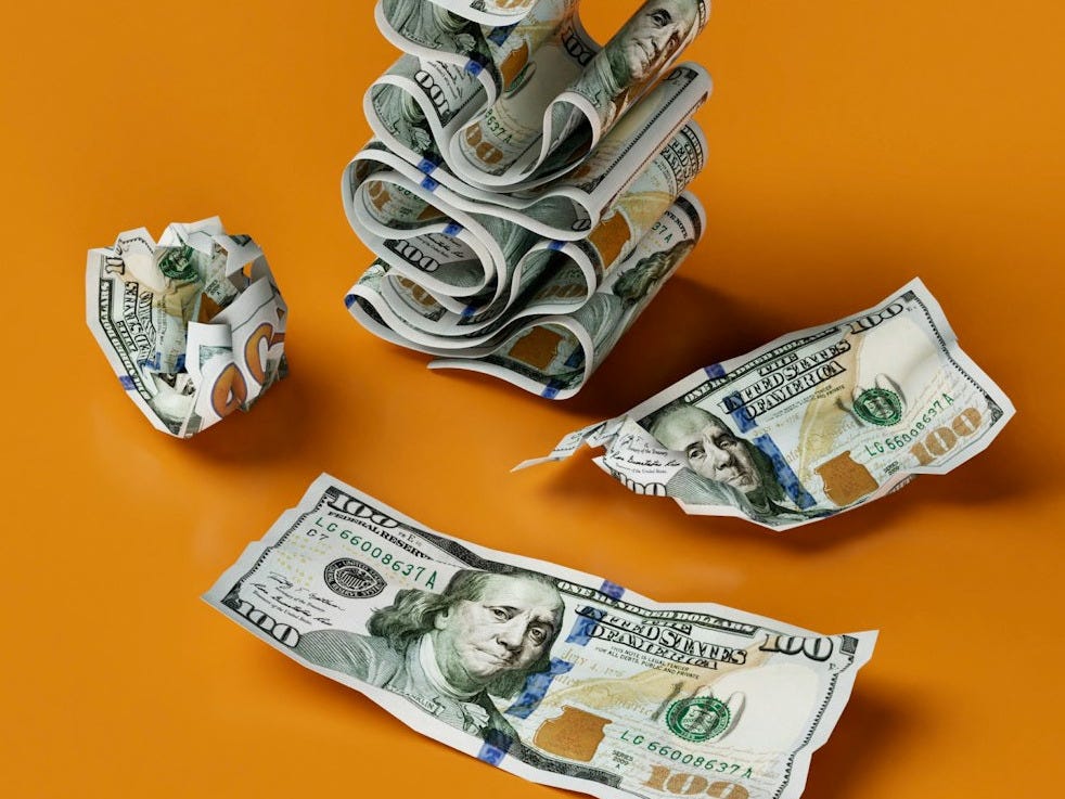 a stack of money sitting on top of a table a stack of money sitting on top of a table