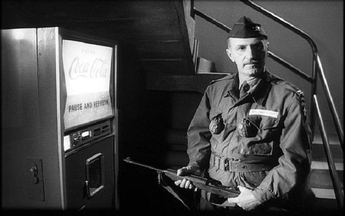 Still image from 'Dr. Strangelove' showing Keenan Wynn as Col. 'Bat'' Guano preparing to shoot a Coke machine. Still image from 'Dr. Strangelove' showing Keenan Wynn as Col. 'Bat'' Guano preparing to shoot a Coke machine.