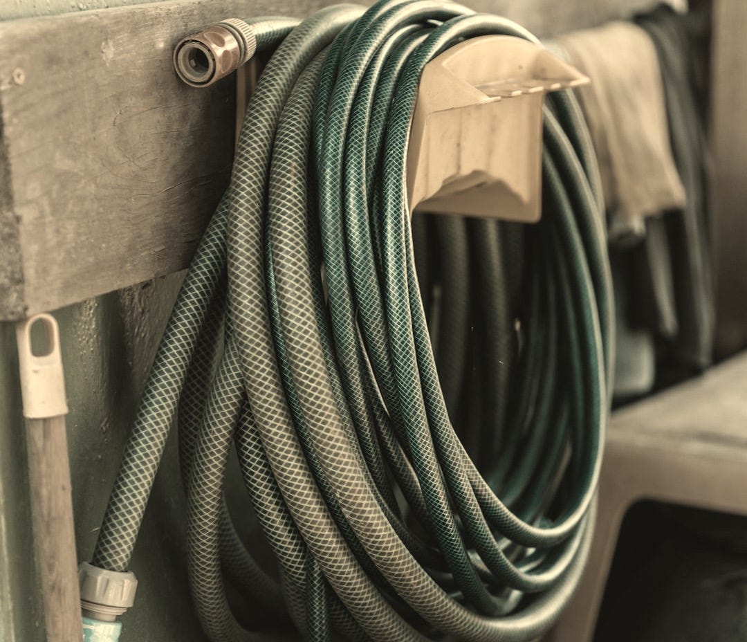 green and yellow hose on brown wooden table