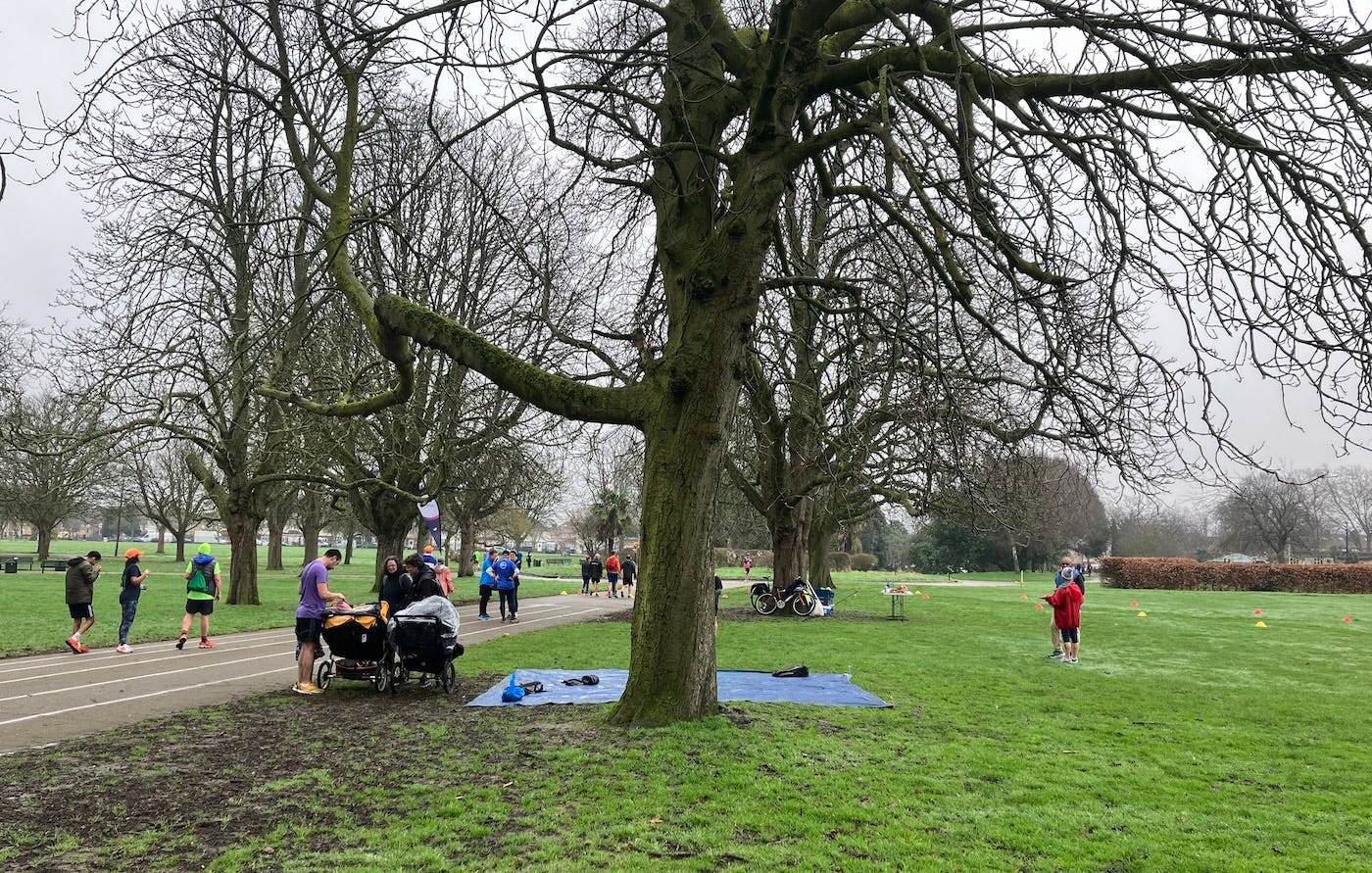 A tarpaulin on the grass for bags, as finishers wander off down the central path