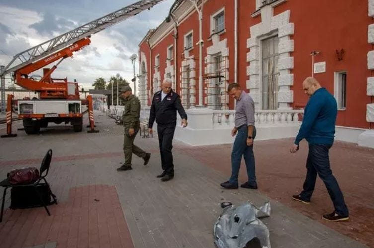 People inspecting an area outside a damaged railway station building following a drone attack in Kursk People inspecting an area outside a damaged railway station building following a drone attack in Kursk