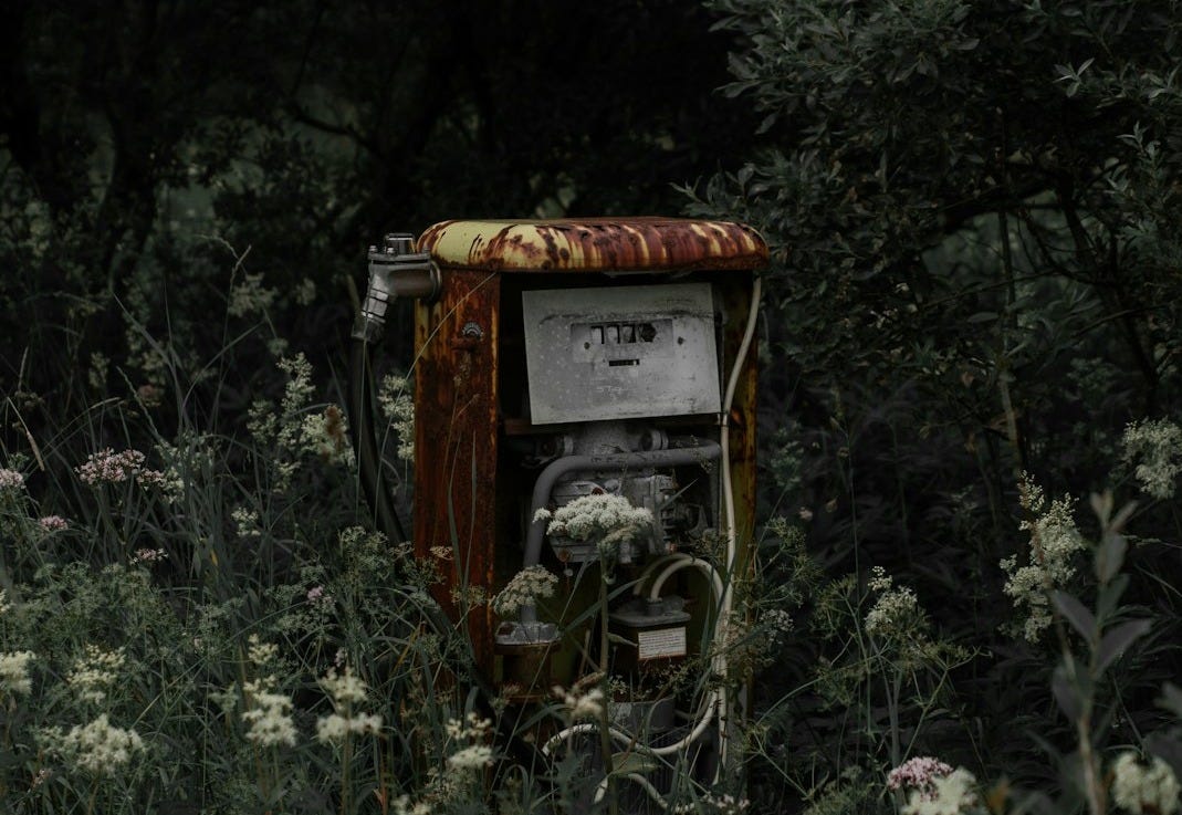 abandoned gas pump by grass field abandoned gas pump by grass field